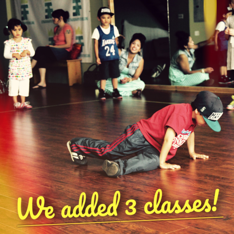 During a Mini BREAKS class, preschool-age students and adults watch a young dancer wearing a red t-shirt and Mariner's baseball hat take their turn dancing in a cypher. Yellow text reads, "We added 3 classes!" Original photo by Ronald Cabang.