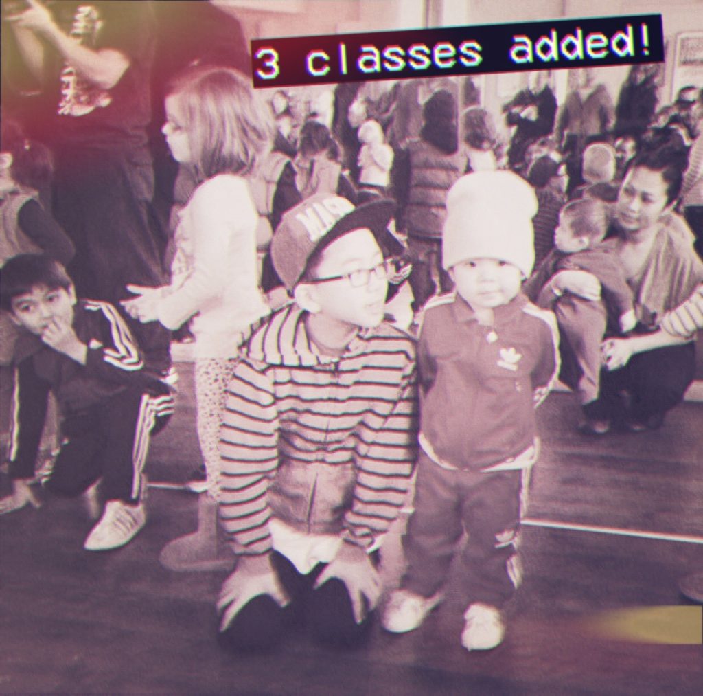 Young children wait for their turn to dance during a Mini BREAKS class. Text at the top of the image reads, "3 classes added!"